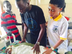 Daniel and Sharon Okabe praying for sick children at Mbale Hospital